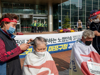 Members of Merchants from the Federation of Street vendors  shave hair during a press conference in front of the Mapo district office on Oct...