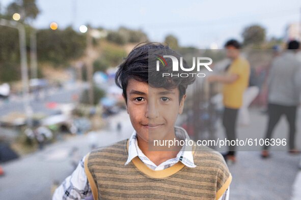 Portrait of a boy at the roof of a building where he lives with his family after the fire of Moria camp. Portraits of young children refugee...