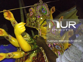 An artisan works on an idol of the Hindu goddess Durga in a workshop giving final touches ahead of the Durga Puja festival at CR Park, on Oc...