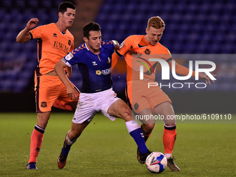 Oldham Athletic's Ben Garrity and Carlise United's Jon Mellish and Callum Guy in action during the Sky Bet League 2 match between Oldham Ath...