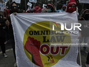 Indonesian female labor take part during a protest against government's new job law (Omnibus Law) on job creation in Bogor, West Java, on Oc...