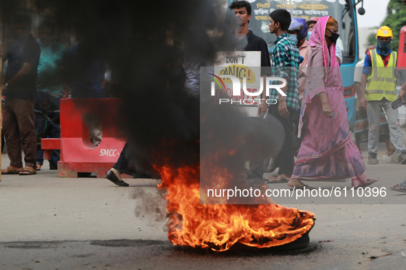 Students and activists block roads as they protest against recent alleged rape and torture of a woman in the southern district of Noakhali,...