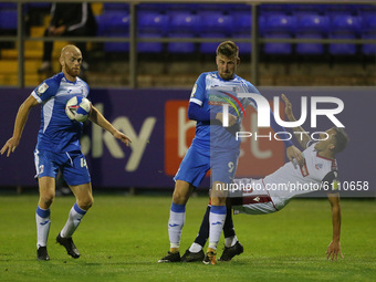   Jason Taylor and Scott Quigley in action with Bolton 's Antoni Sarcevic   during the Sky Bet League 2 match between Barrow and Bolton Wand...