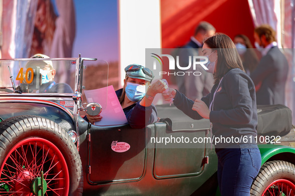 A driver of historic car clening his hands at the start of the  Mille Miglia in Brescia, Italy on October 21, 2020.  Although the departure...
