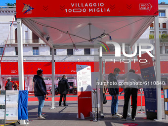 Control process at the entry gate of the 'Mille Miglia' red carpet historic cars in Vittoria Square, Brescia, Italy on October 21, 2020. Alt...