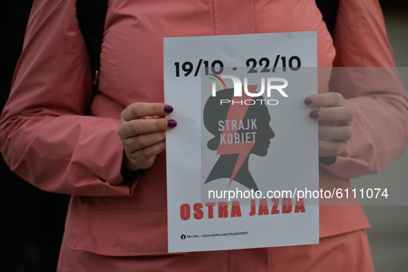 Pro-Choice activist holding a logo of the 'Women Strike', seen in the center of Krakow, part of the Coronavirus Red Zone, during a protest a...