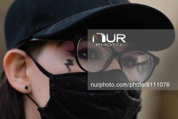Pro-Choice activist with a logo of the 'Women Strike' on the cheek, seen in the center of Krakow, part of the Coronavirus Red Zone, during a...
