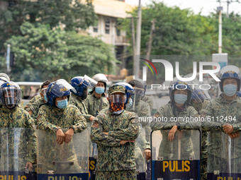 Riot police stand guard the perimeter along Mendiola as the protesters converged , calling for the junking of the Rice Tariffication Law and...