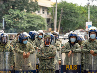 Riot police stand guard the perimeter along Mendiola as the protesters converged , calling for the junking of the Rice Tariffication Law and...