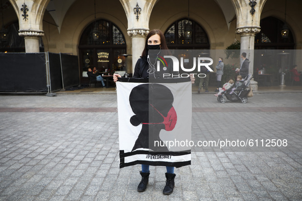 A protestor wears a face mask due to the spread of coronavirus, while standing in a queue at the Main Square and protesting against imposing...