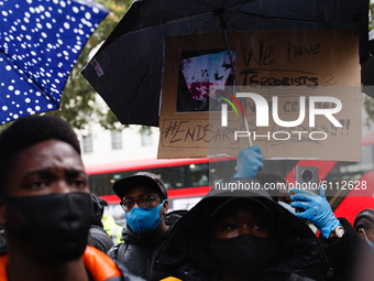 Activists protesting police brutality by the Nigerian Special Anti-Robbery Squad (SARS) demonstrate Downing Street on Whitehall in London, E...
