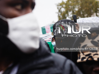 Activists protesting police brutality by the Nigerian Special Anti-Robbery Squad (SARS) demonstrate in Parliament Square in London, England,...
