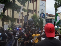 Protesters jubilate as military men dispatched to disperse them in Alausa, Ikeja, Lagos, Nigeria exchange knuckles and take selfie with the...
