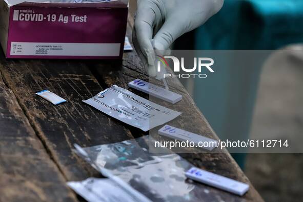 A Medical worker uses Rapid Antigen Testing (RAT) strips after collecting a swab to collect sample from commercial drivers for COVID-19 (Cor...