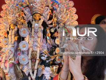 BJP women's wing president in West Bengal Agnimitra Paul near an idol of the ten-armed Hindu Goddess Durga at the virtual inauguration of Bh...