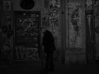 (EDITOR'S NOTE: IMAGE HAS BEEN CONVERTED TO BLACK AND WHITE) A man  wearing face mask walks in Trastevere district as Italy is facing a surg...