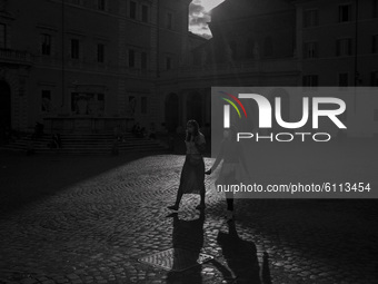 Italy, Rome:  (EDITOR'S NOTE: IMAGE HAS BEEN CONVERTED TO BLACK AND WHITE) People wearing face mask walk in Trastevere district as Italy is...