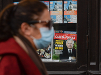 A woman wearing a protective mask walks by a kiosk with the image of Jaroslaw Kaczyński on the front page of Gazeta Polska.
Polish Prime Min...