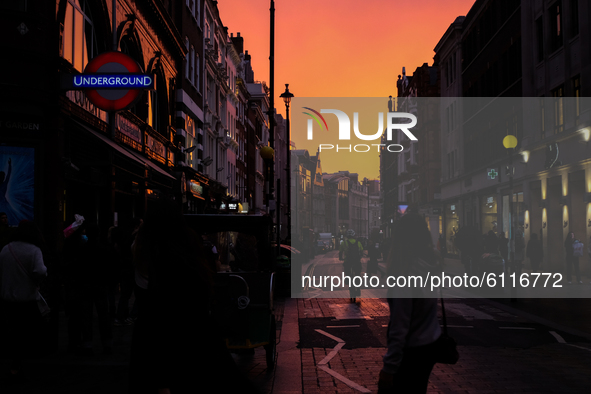 The sun sets on the Long Acre, in Covent Garden, London on October 23, 2020. 