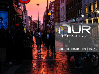 The sun sets on the Long Acre, in Covent Garden, London on October 23, 2020. (