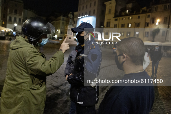 A civil argue with a police man in the city center of Rome, Italy, on October 23, 2020 amid the nightly curfew due the COVID-19 pandemic. Lo...