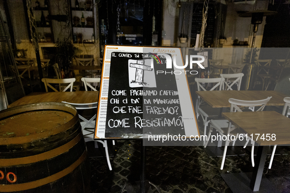 A sign in front of a restaurant in Campo Dei Fiori, Rome, Italy, on October 23, 2020 amid the nightly curfew due the COVID-19 pandemic. Loca...