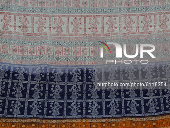 Tribals traditional painting art are seen on their handmade saree as it is displaying at the state government run business counter in the ea...