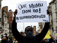 A group of people gather to protest against brutality of Nigerian Special Anti-Robbery Squad (SARS) in London, Britain, 24 October 2020. UN...