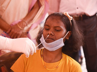 A girl going through  Rapid Antigen Test for COVID-19 before enter to the Kamakhya Temple during Durga puja festival, in Guwahati, India on...