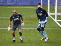 L-R Goalkeeping Coach: Lee Turner and  Bartosz Bialkowski of Millwall during the pre-match warm-up  during Sky Bet Championship between Mill...