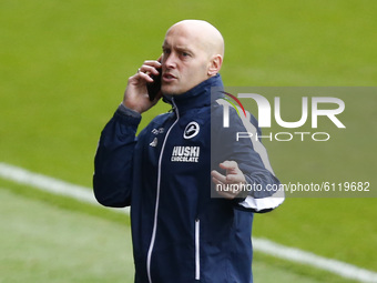  Millwall Assistant Manager: Adam Barrett getting Instructions on phone from Manger Gary Rowett during Sky Bet Championship between Millwall...