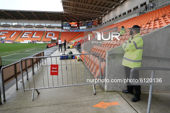 A barrier indicating the red zone in compliance with the COVID-19 pandemic rules is seen by the dugouts prior to the Sky Bet League 1 match...