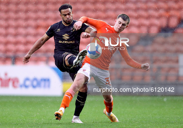 Milton Keynes Dons' Louis Thompson competes for possession with Blackpool's Ben Woodburn during the Sky Bet League 1 match between Blackpool...
