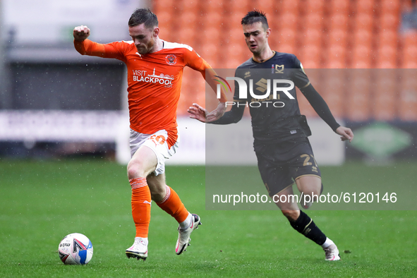 Blackpool's Oliver Turton (left) in action with Milton Keynes Dons' Daniel Harvie during the Sky Bet League 1 match between Blackpool and MK...