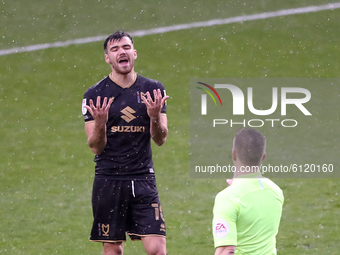 Milton Keynes Dons' Scott Fraser reacts to referee Marc Edwards (right) awarding a foul during the Sky Bet League 1 match between Blackpool...