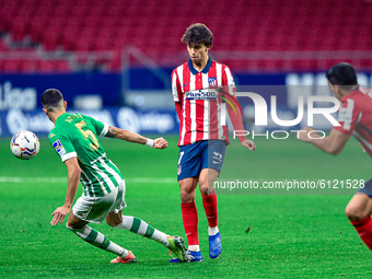 Joao Felix and Marc Bartra during La Liga match between Atletico de Madrid and Real Betis at Wanda Metropolitano on October 18, 2020 in Madr...