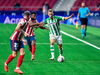 Thomas Lemar and Sergio Canales during La Liga match between Atletico de Madrid and Real Betis at Wanda Metropolitano on October 18, 2020 in...