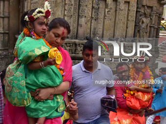 Hindu devotees carry girls dressed as the Hindu goddess Durga for the 