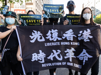 Protesters holding a flag with the text: Liberate Hong Kong, Revolution of our Times on October 25, 2020 in Taipei, Taiwan. On Saturday Taiw...