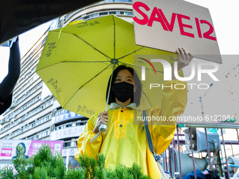 A protester holding a sign with the words: Save12,  on October 25, 2020 in Taipei, Taiwan. On Saturday Taiwan, Tibetans, Hongkongers, Thaila...