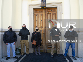 Members of the far-right group Mlodziesz Wszechpolska (All-Polands youth) guard the entrance of the church during a protest against tghtenin...