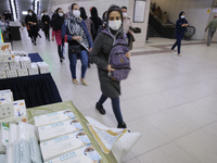 An Iranian woman wearing a protective face mask to prevent herself of infection by the new coronavirus disease (COVID-19) walks past protect...