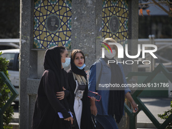 Iranian women wearing protective face masks to prevent themselves of infection by the new coronavirus disease (COVID-19) walk along a street...