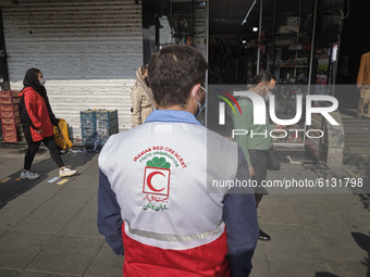 A member of Iran Red Crescent Society (C) looking for people who may not use protective face masks, amid the new coronavirus disease (COVID-...