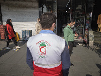A member of Iran Red Crescent Society (C) looking for people who may not use protective face masks, amid the new coronavirus disease (COVID-...