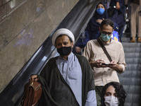 An Iranian cleric wearing a protective face mask to prevent himself of infection by the new coronavirus disease (COVID-19), in an undergroun...