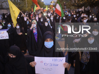 An Iranian female protester holds a placard with a Hebrew script that reads, I Love Mohammad, during a protest gathering in front of the Fre...