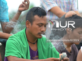 Naga youth smoke Bidi, a leaf hand rolled cigarette on World No Tobacco Day in Dimapur, India north eastern state of Nagaland on Sunday, May...