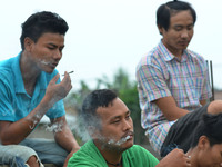 Naga youth smoke Bidi, a leaf hand rolled cigarette on World No Tobacco Day in Dimapur, India north eastern state of Nagaland on Sunday, May...