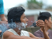 A Naga youth smoke Bidi, a leaf hand rolled cigarette on World No Tobacco Day in Dimapur, India north eastern state of Nagaland on Sunday, M...